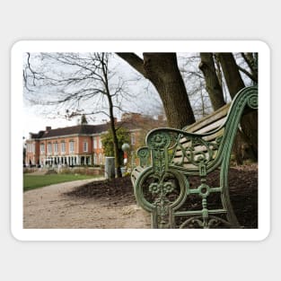 A bench in the park with a background of  South Hill Park Arts Centre, Bracknell, England, UK Sticker